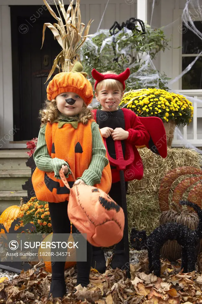 Portrait of Girl Dressed-up as Pumpkin and Boy Dressed-up as Devil   