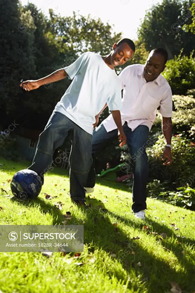 Father and Son Playing in Backyard   