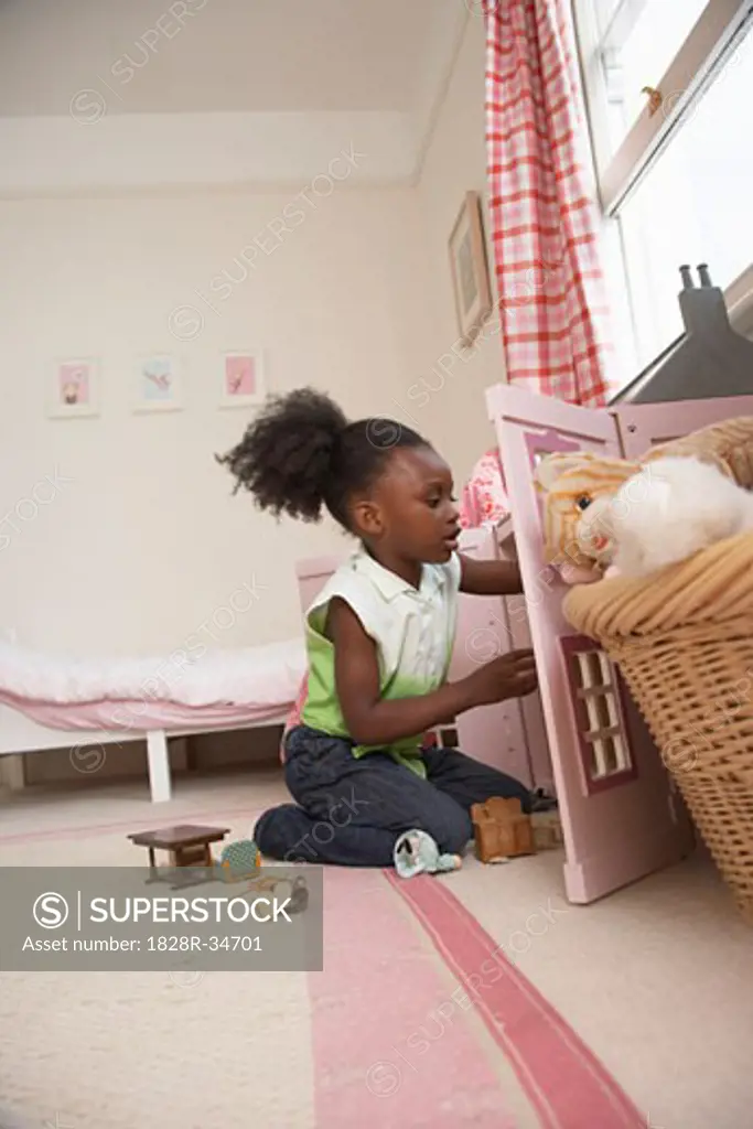 Girl Playing with Dollhouse   