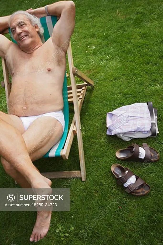 Man Sitting in Lawn Chair in His Underwear - SuperStock
