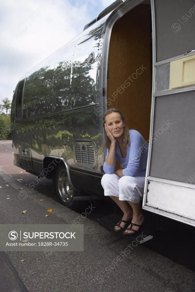 Woman Sitting Outside Trailer   
