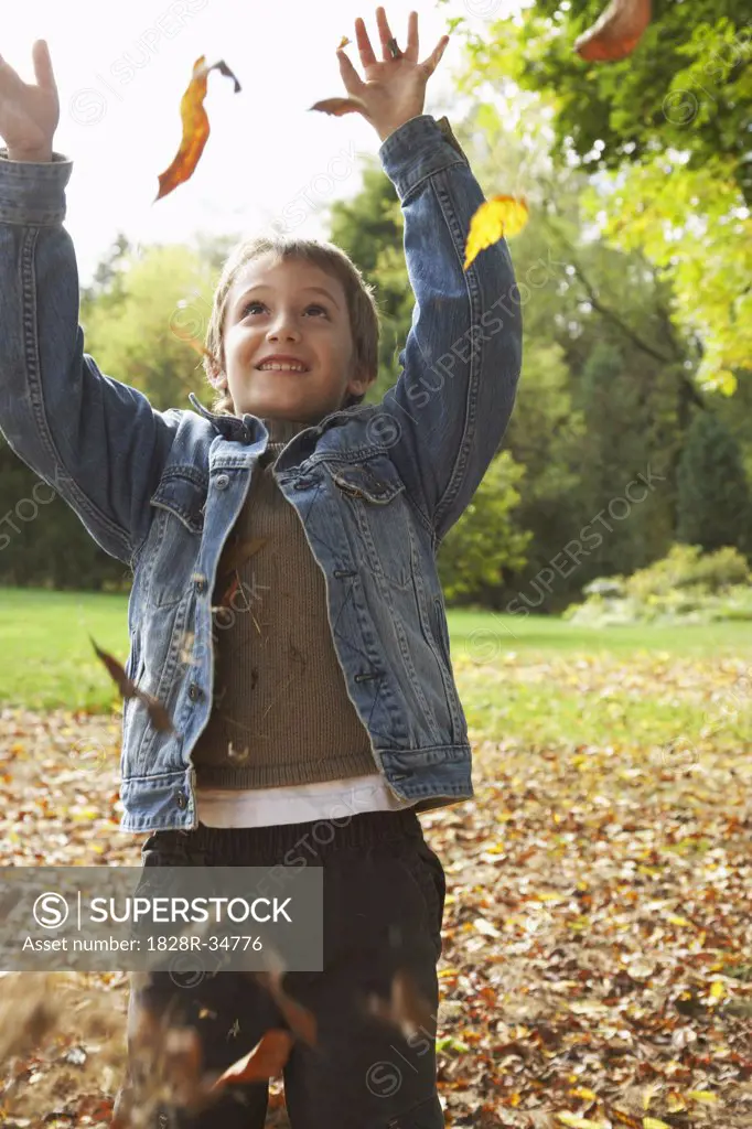 Boy Throwing Leaves in Air   