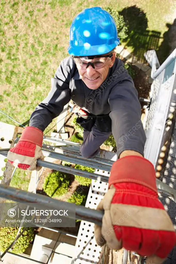 Construction Worker Climbing Scaffold   