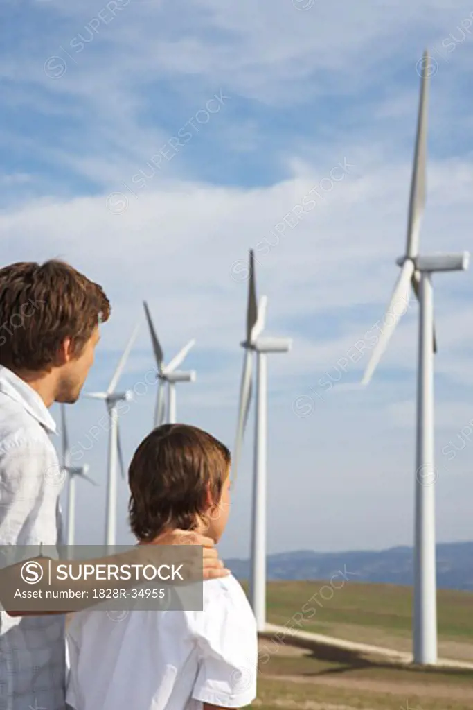 Father and Son Looking at Wind Turbines   