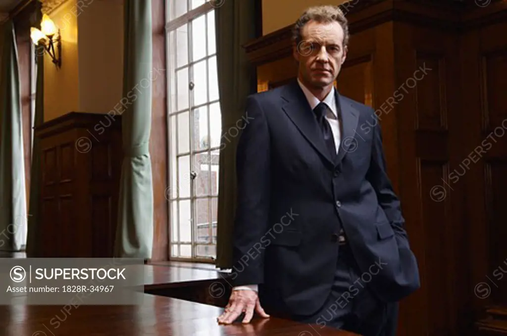 Businessman in Large Boardroom   