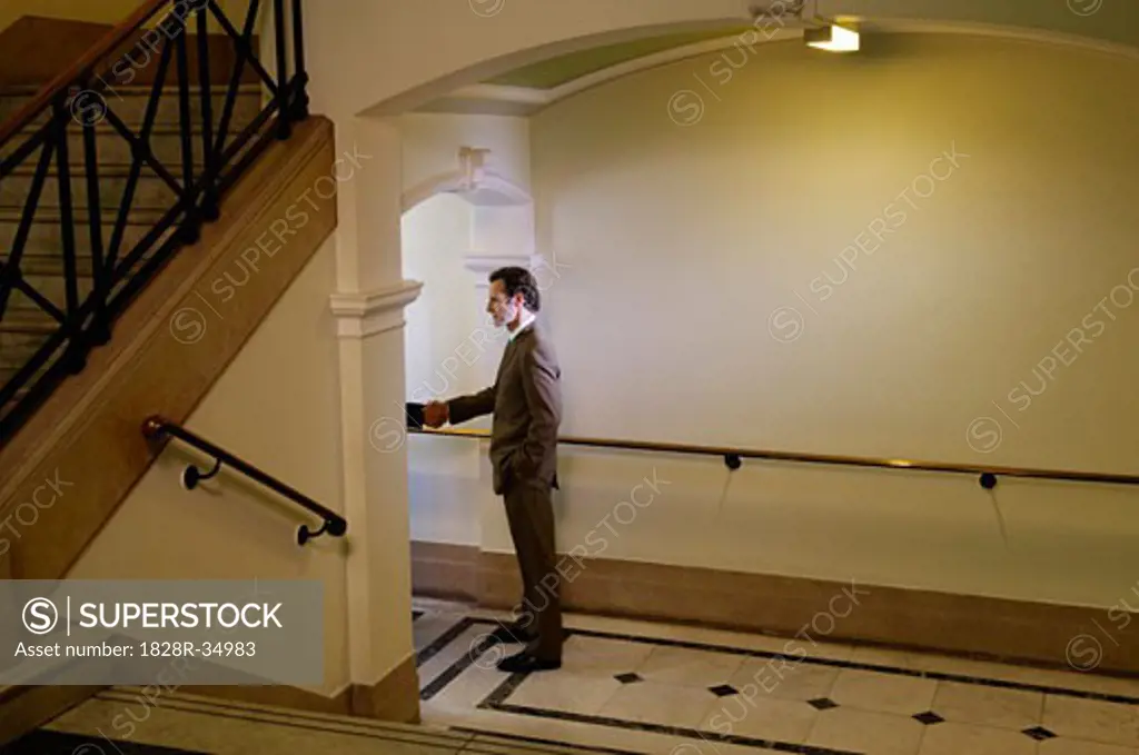 Businessmen Shaking Hands in Hallway   