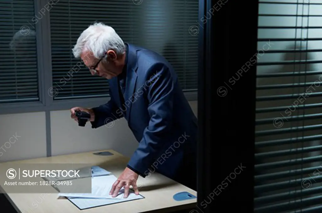 Businessman Photographing Document   