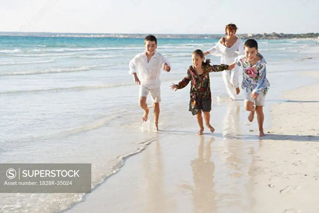 Family Running on the Beach   