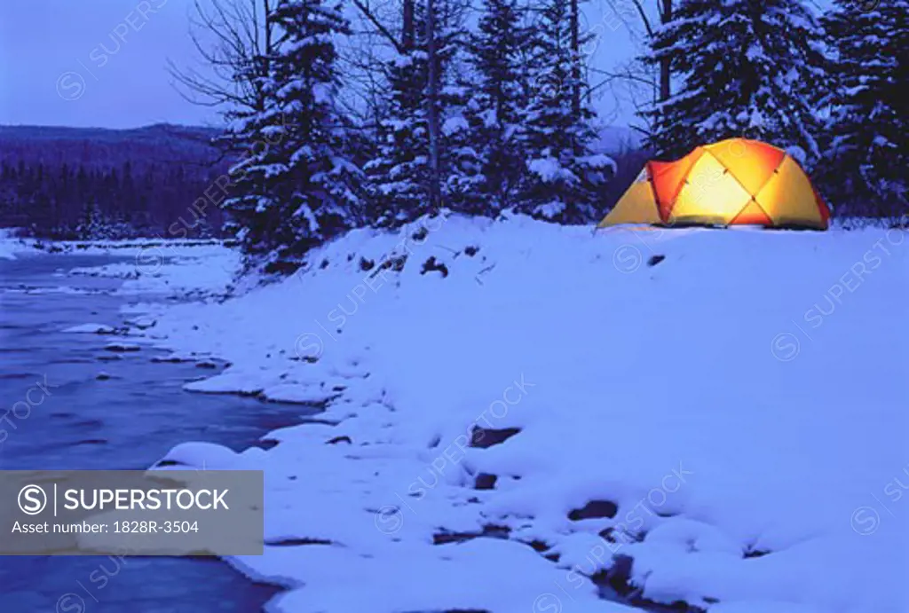 Glowing Tent near River in Winter Kananaskis Country, Alberta Canada   