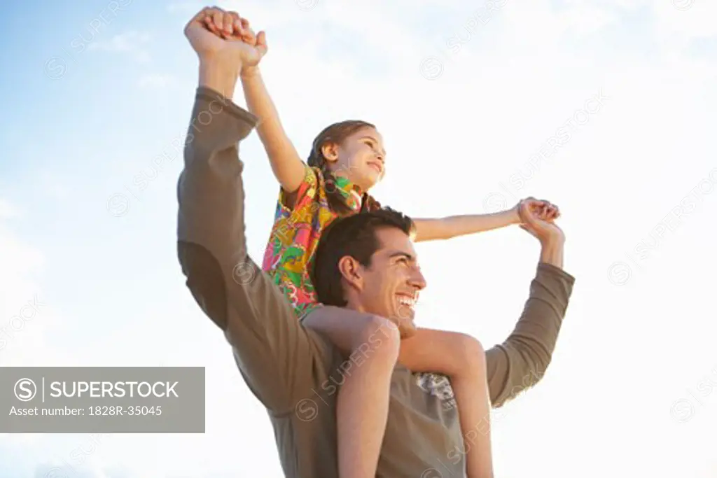 Father Giving Daughter Piggyback Ride   