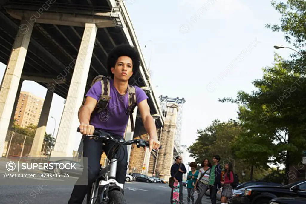 Teenaged Boy on Bicycle   