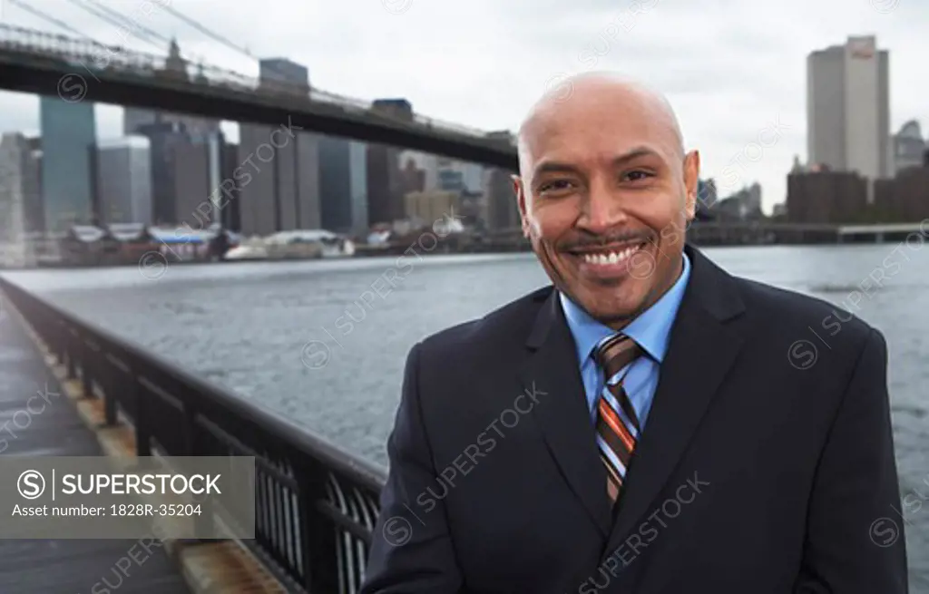 Businessman by Brooklyn Bridge, New York City, New York, USA   