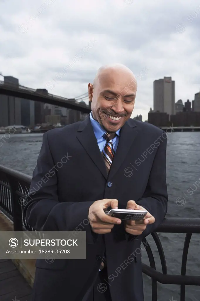Businessman by Brooklyn Bridge, New York City, New York, USA   