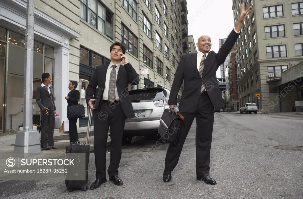 Businessmen Hailing Taxi, New York City, New York, USA   