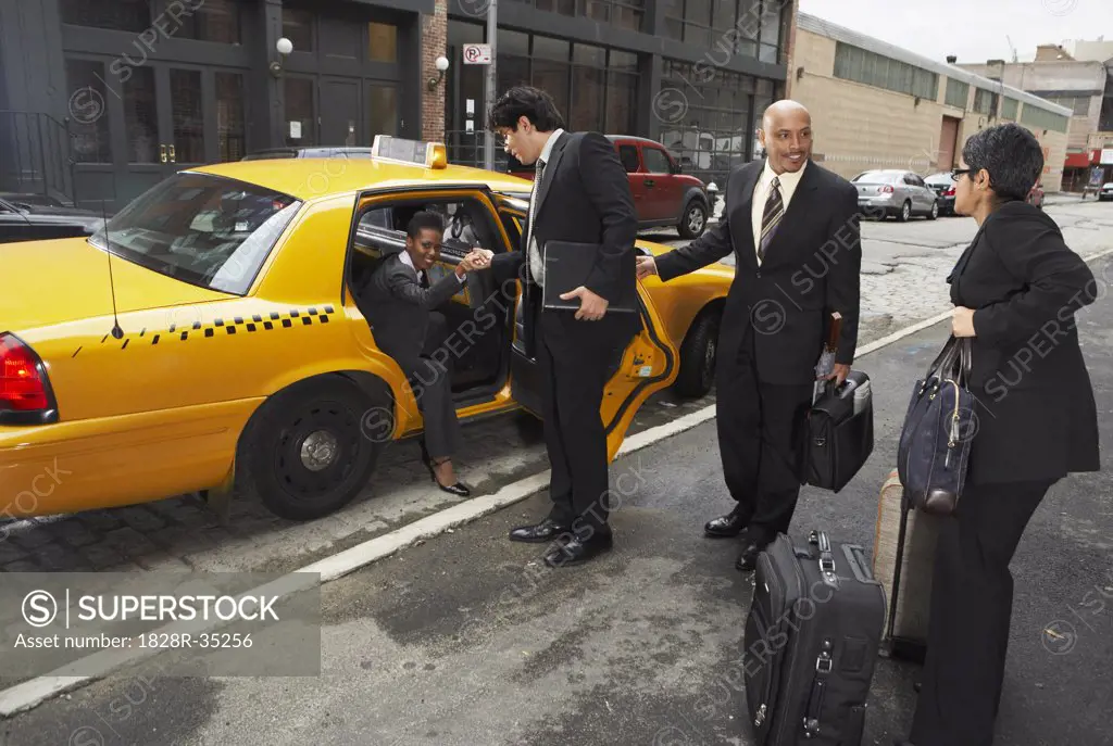 Business People Sharing Taxi Cab, New York City, New York, USA   