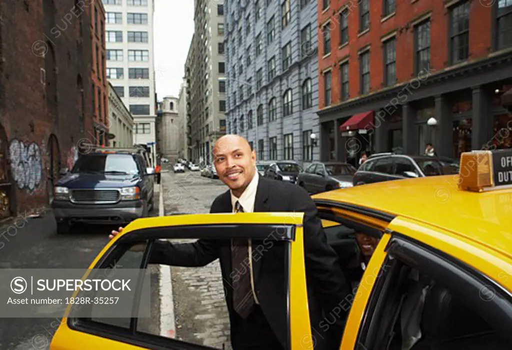 Businessman Exiting Taxi, New York City, New York, USA   