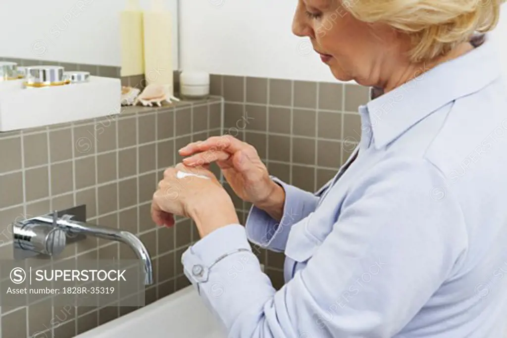 Woman Applying Hand Cream   