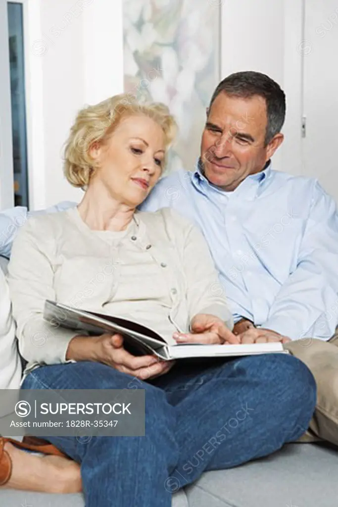 Couple on Sofa with Book   