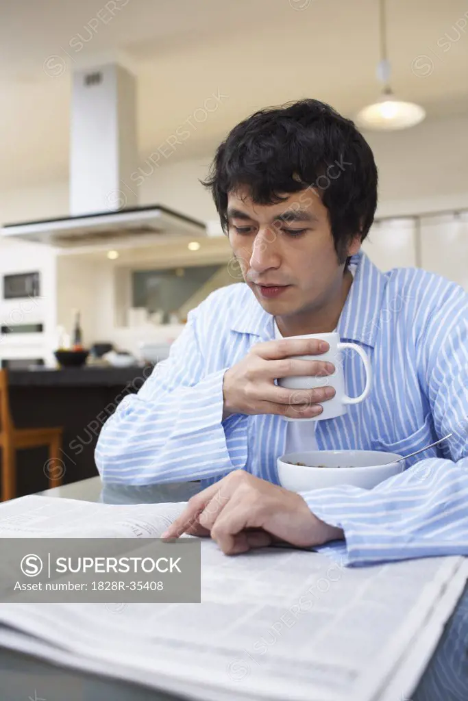 Man Drinking Coffee, Reading Newspaper   