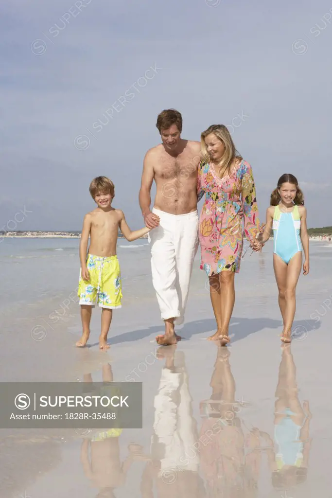 Family Walking along Beach, Majorca, Spain   