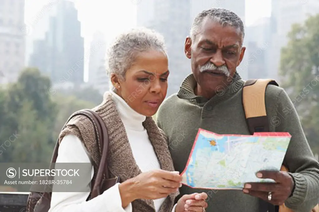 Couple in City with Map, New York City, New York, USA   