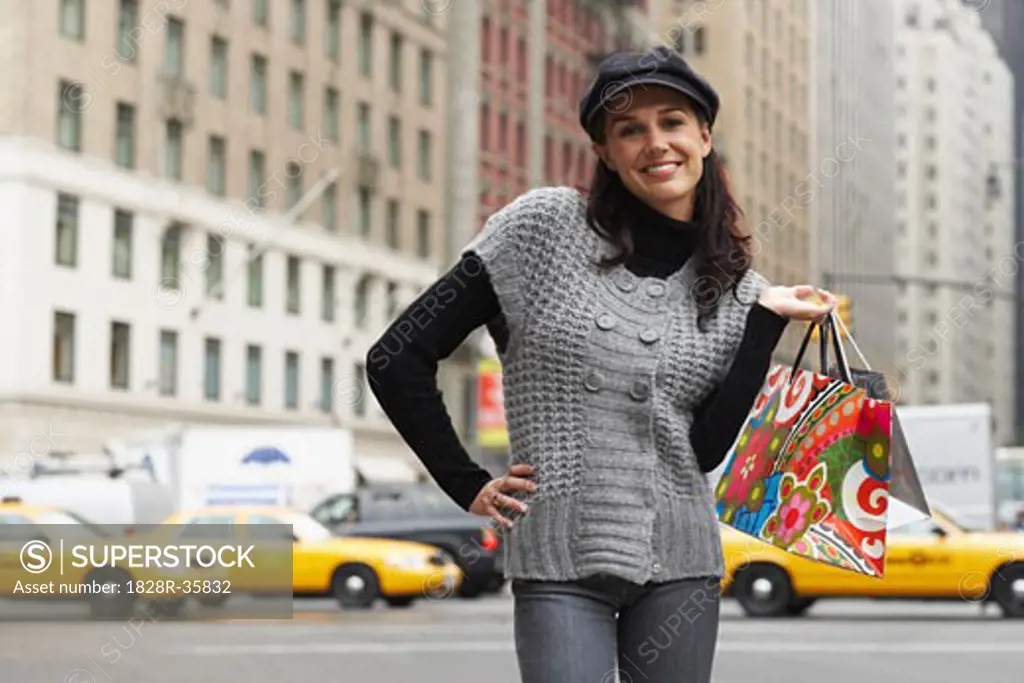 Portrait of Woman in City with Shopping Bags, New York City, New York, USA   