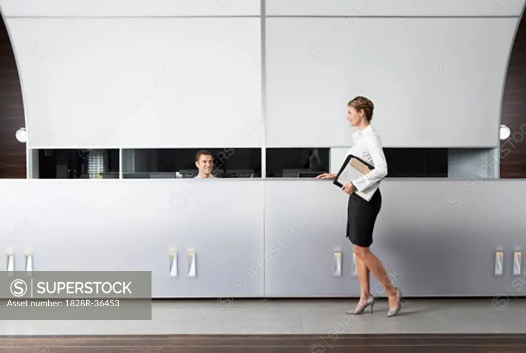 Receptionist and Businesswoman at Desk   