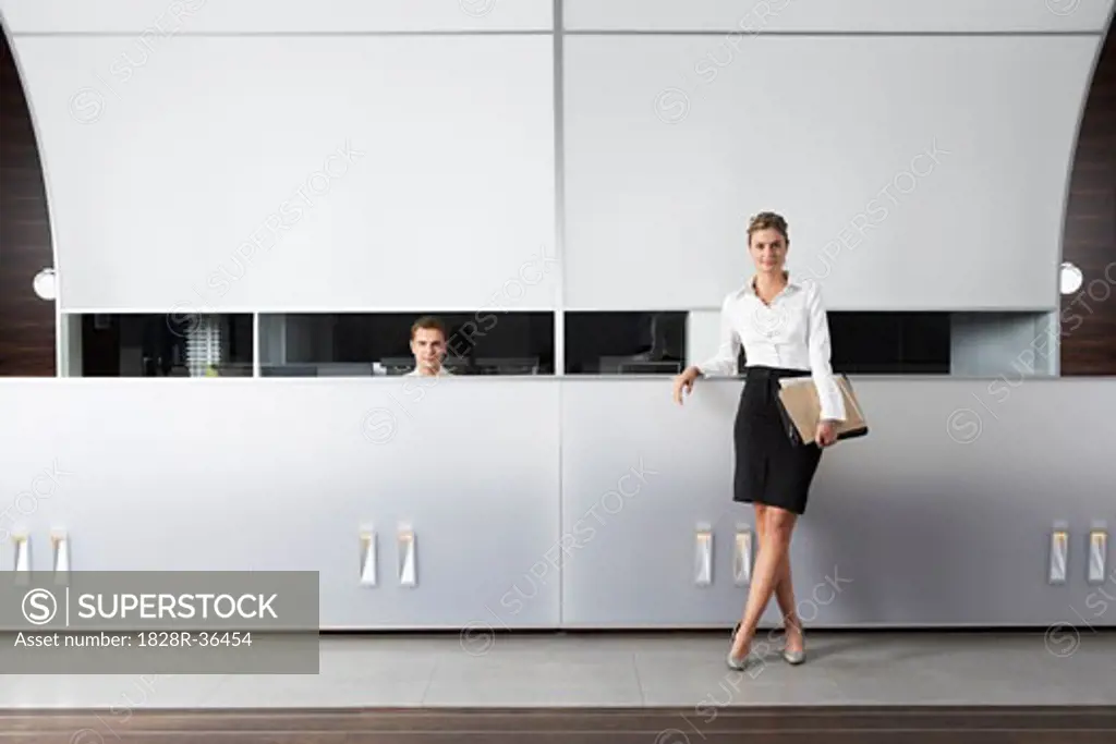 Receptionist and Businesswoman at Desk   