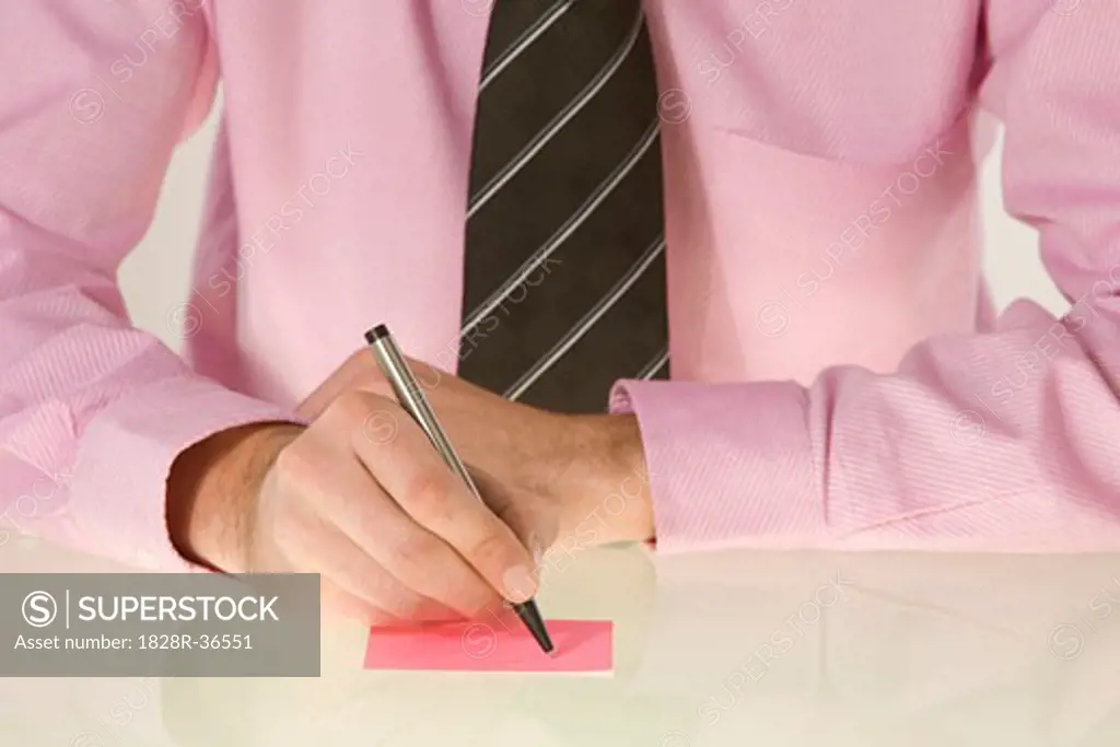 Businessman Writing on Sticky Note   