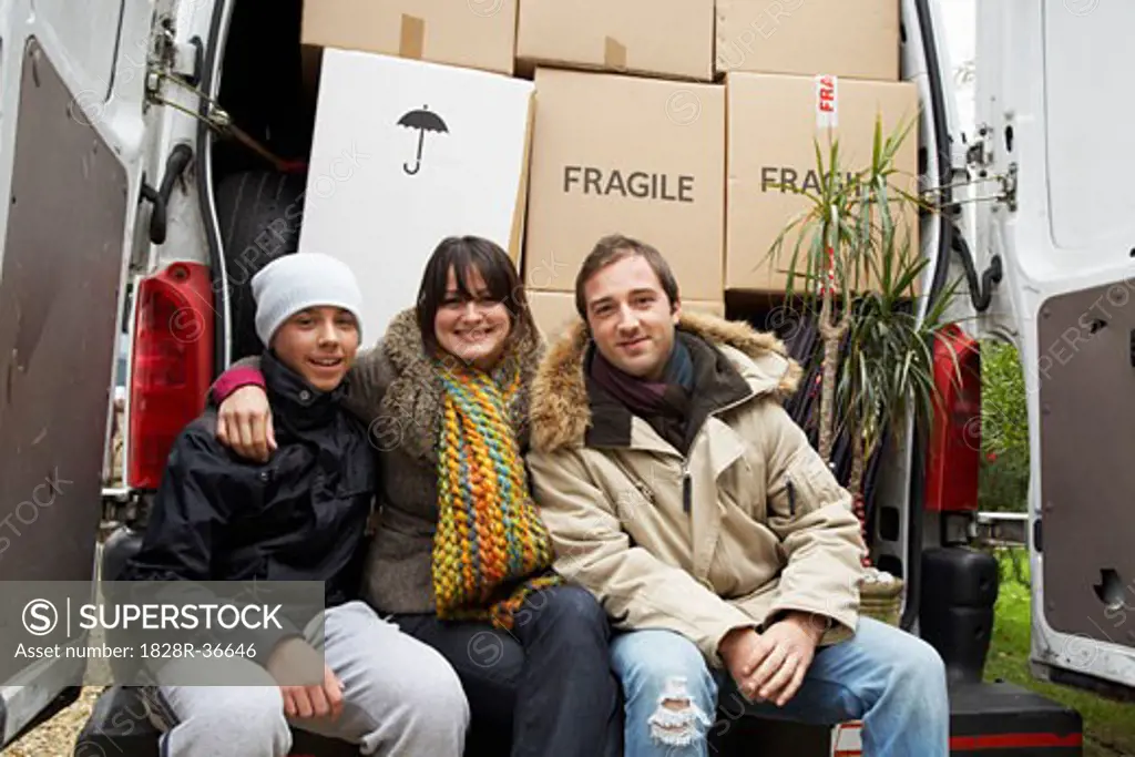 Family Sitting on Back of Moving Van   