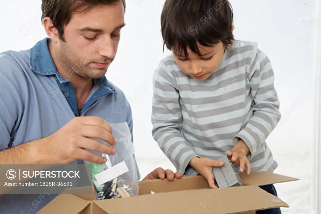 Father and Son Looking through Box   