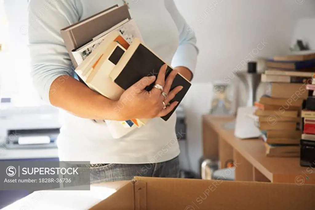 Woman Packing Books into Box   
