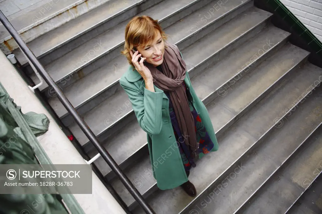Woman Talking on Cell Phone on Stairs   
