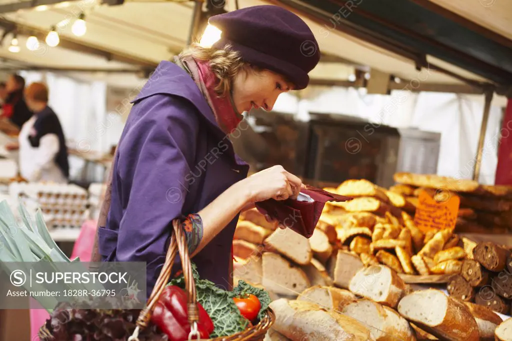 Woman Paying at Bread Stand at Outdoor Market   