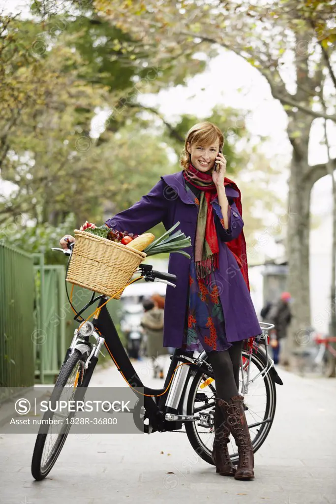 Woman with Bicycle on Cell Phone   