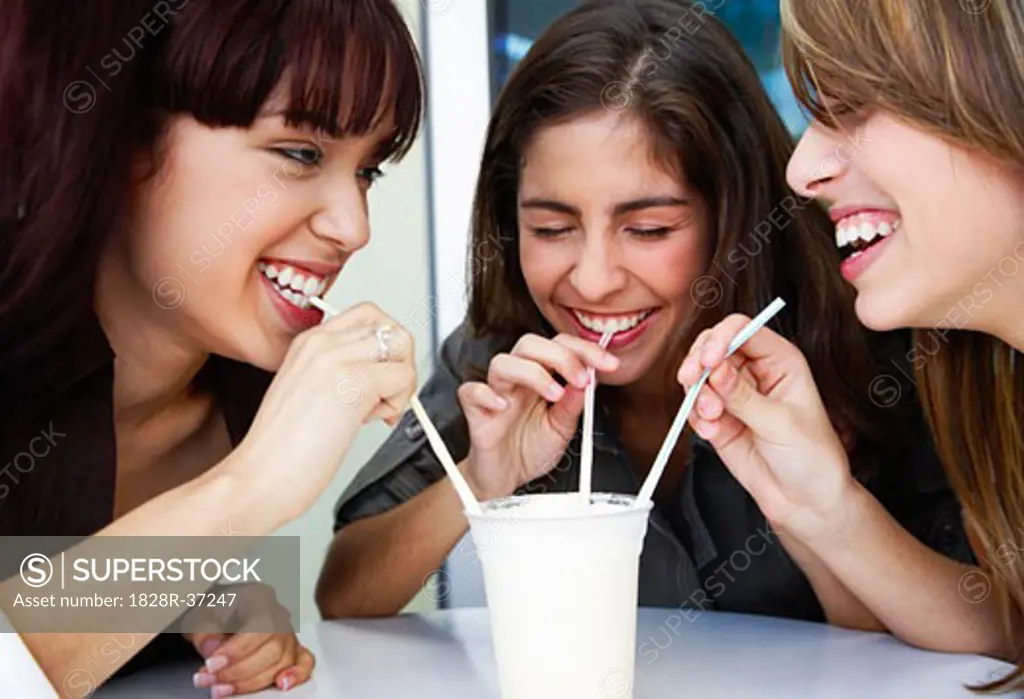 Girls Sharing Milkshake   