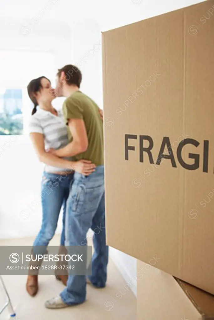 Couple Kissing in New Home   
