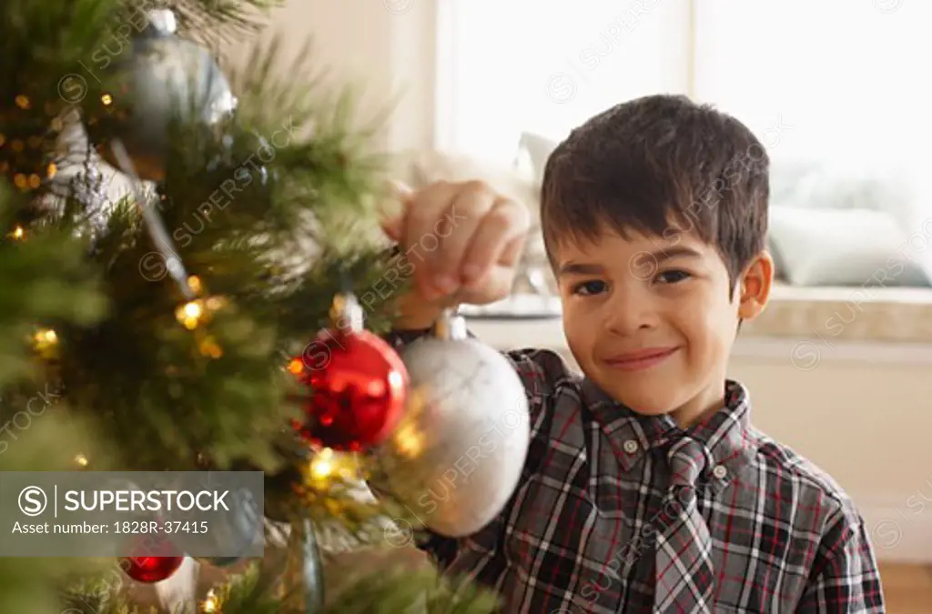 Boy Decorating Christmas Tree   