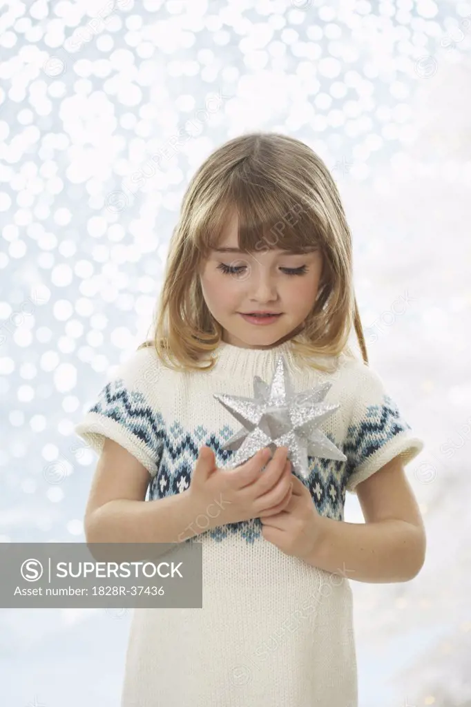 Portrait of Girl Holding Christmas Decoration