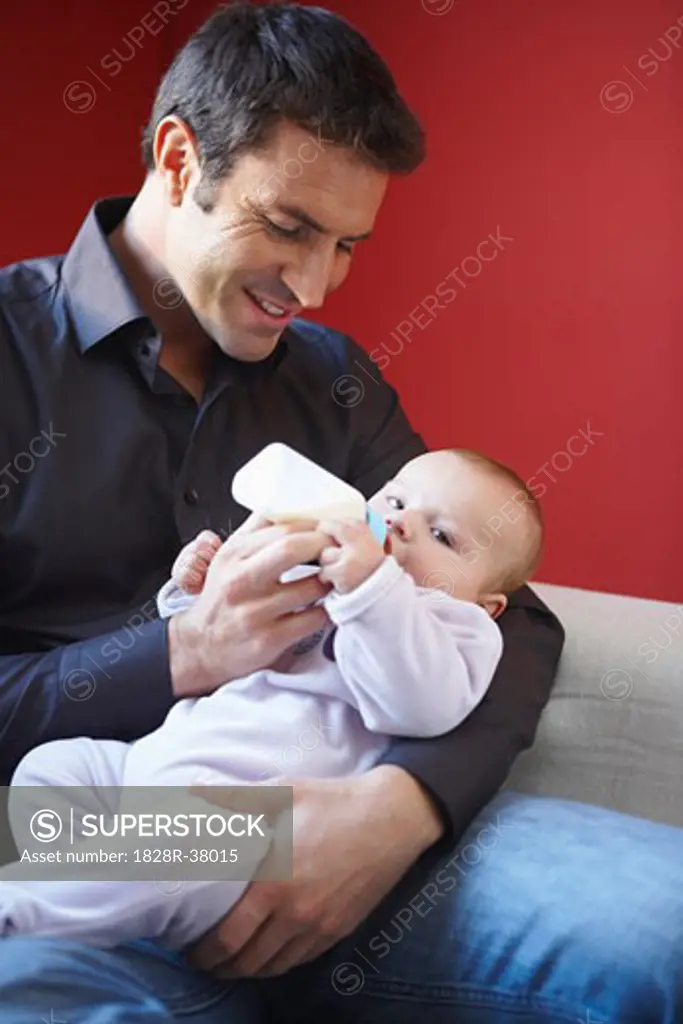 Father Feeding Baby with Bottle   