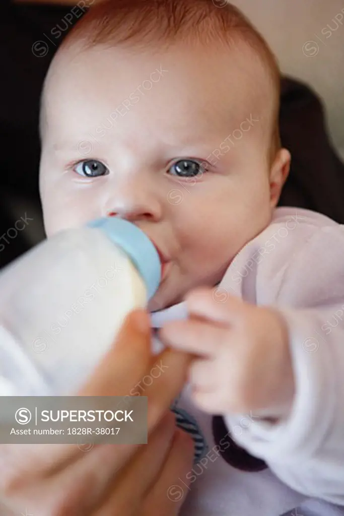 Hand Feeding Baby with Bottle   