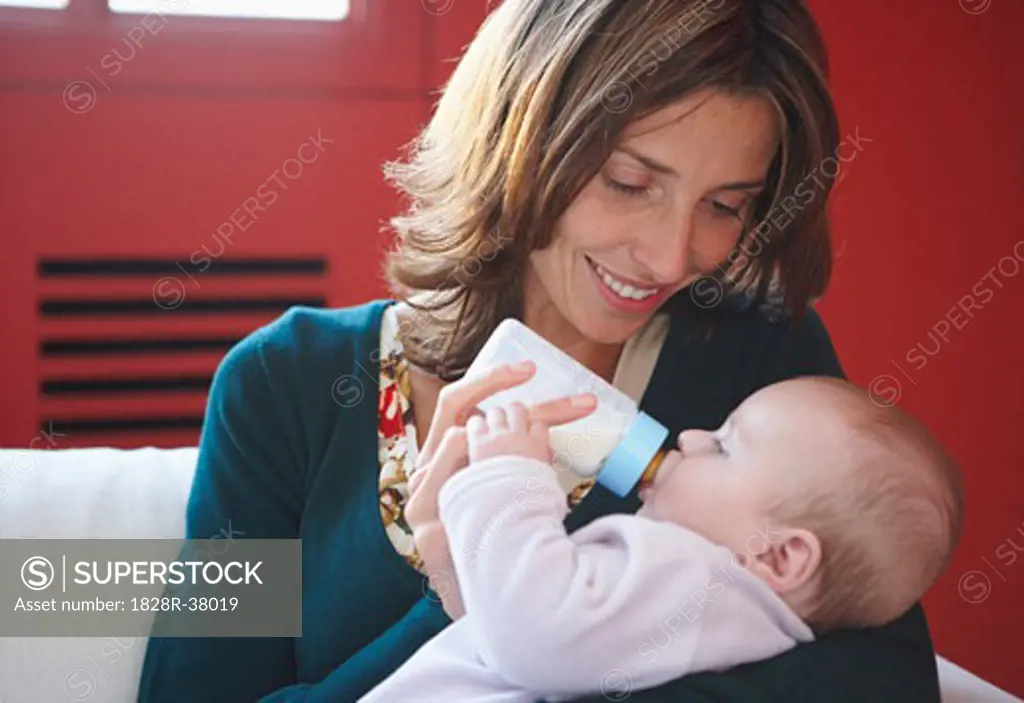 Mother Feeding Baby with Bottle   