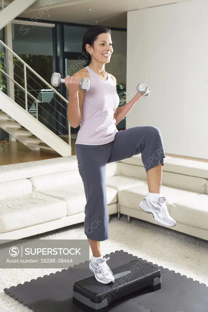 Woman Exercising in Living Room   