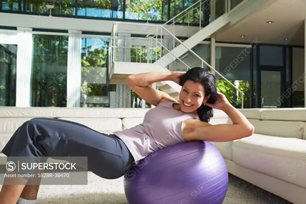 Woman Exercising in Living Room   