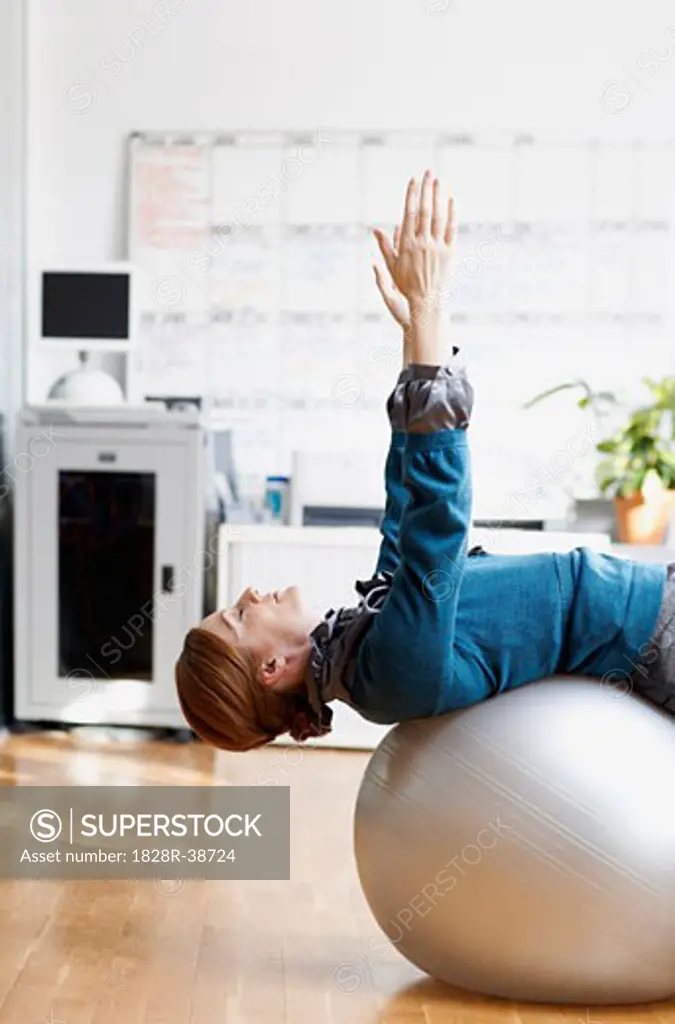 Woman using Exercise Ball in Office   