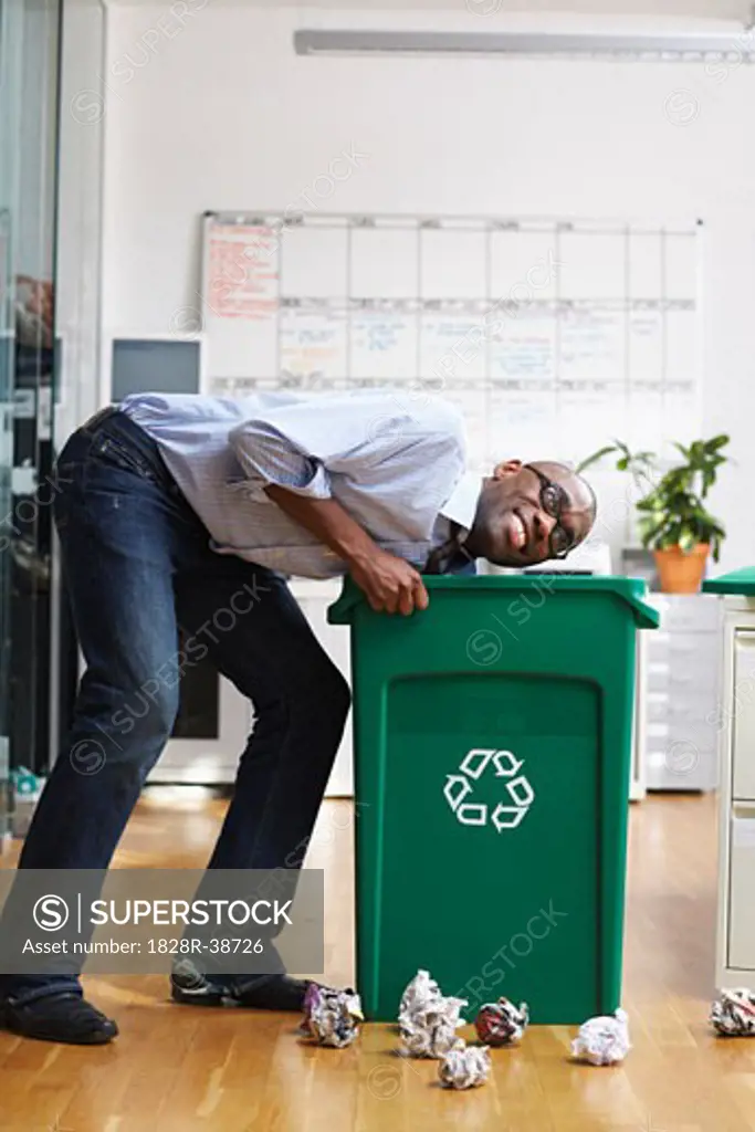 Man Searching through Recycling Bin   