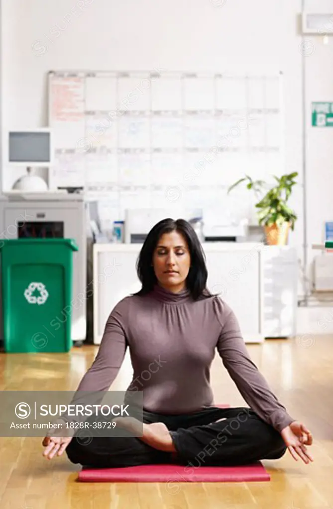 Woman Meditating in Office   