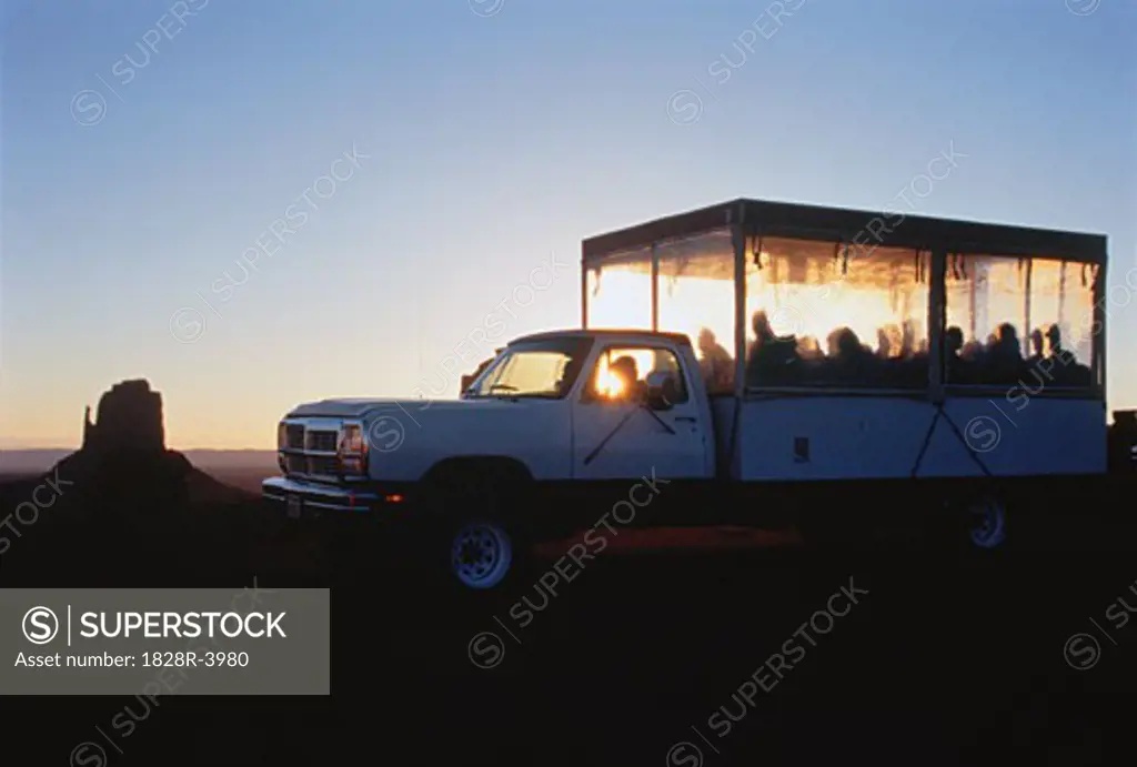 Tour Group in Truck at Sunset Monument Valley, Arizona, USA   
