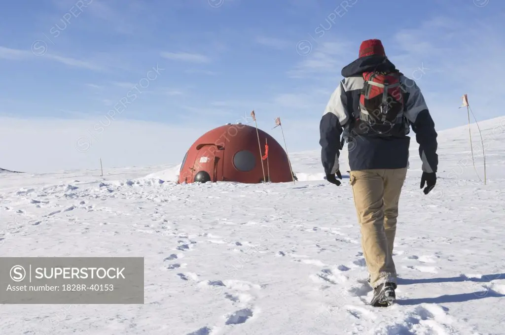 Hiker Approaching Emergency Shelter in Castle Rock Loop, Ross Island, Antarctica   