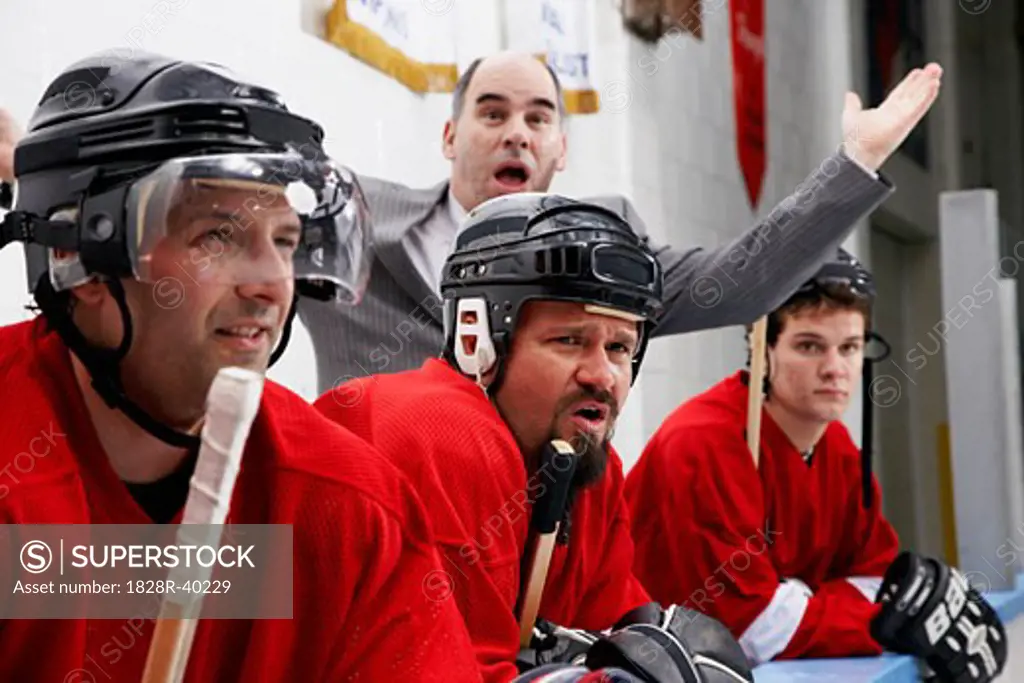 Coach and Hockey Players on the Bench   